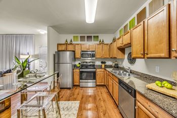 A kitchen with wooden cabinets 
